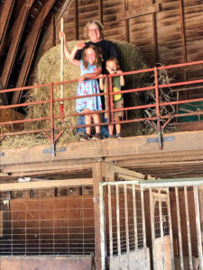 Janice and her grandkids clean the hay loft and pitch hay to the horses.