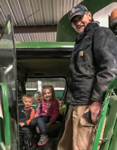Phil and his grandkids share a fun moment together in the combine cab inside of the Farm Shop.