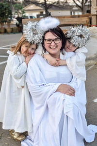 Trish and her two daughters are dressed as angels for the live nativity event.