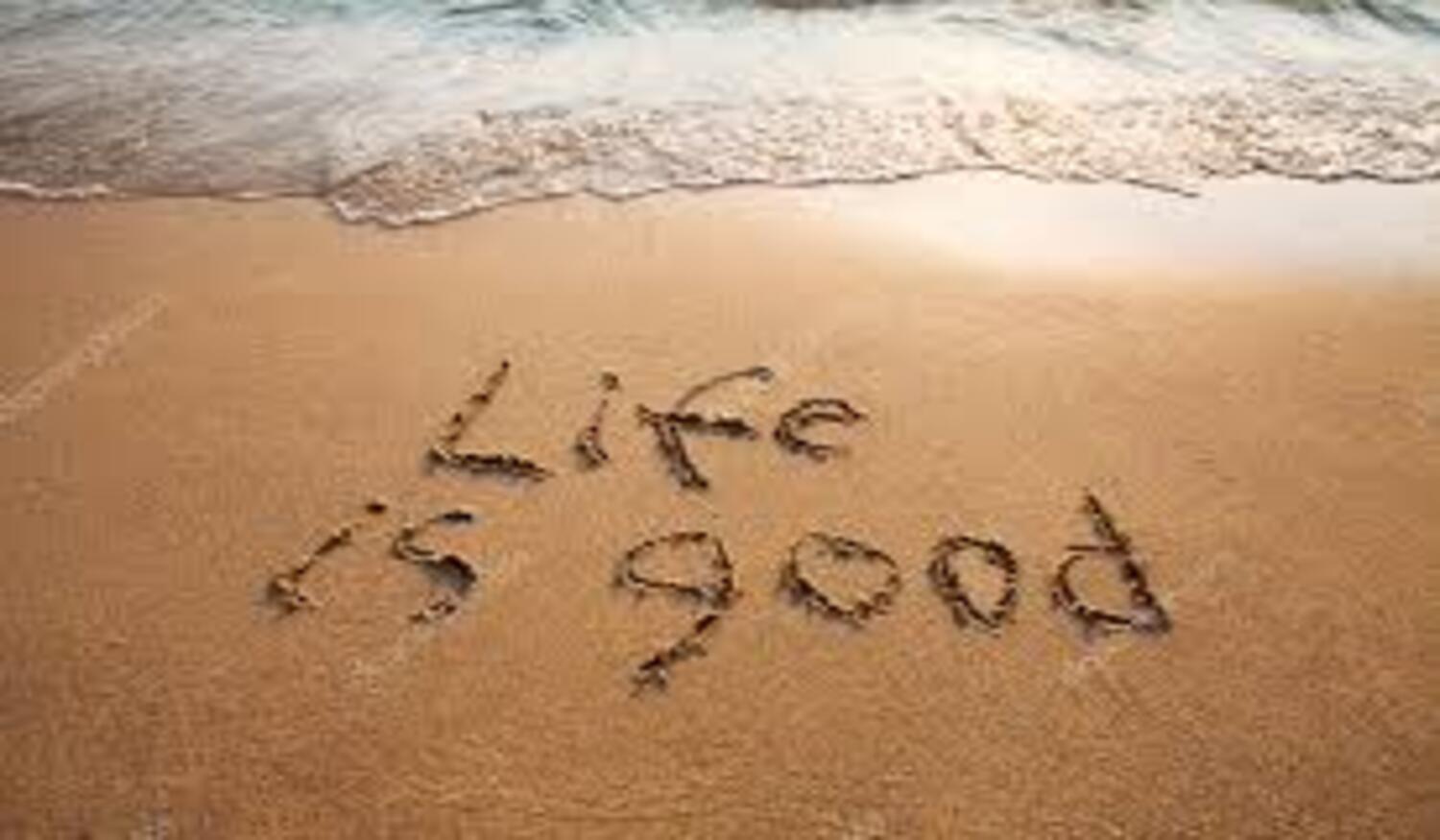 The good life - "Life is Good" written in the sand of a beach