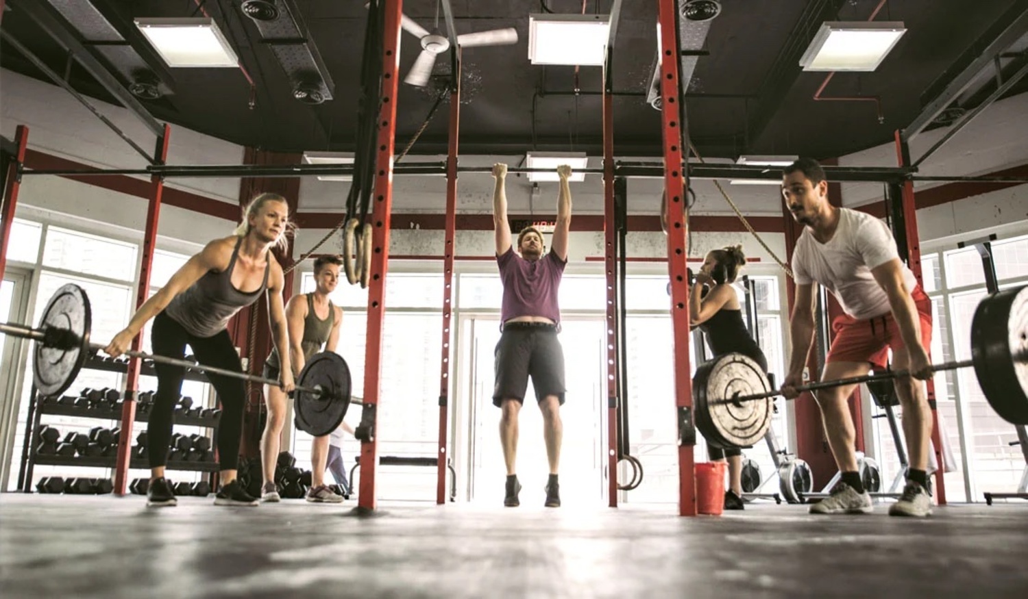 A group of people exercise and lift weights