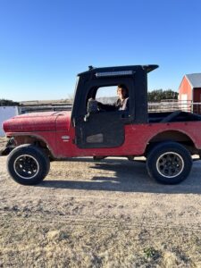 Ron Stoddard, an employee at Bamesberger Farms, stops briefly for a photo op