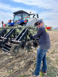 Brenton Ellis, a Bamesberger Farms employee, works on a row unit on the 1tRIPr machine